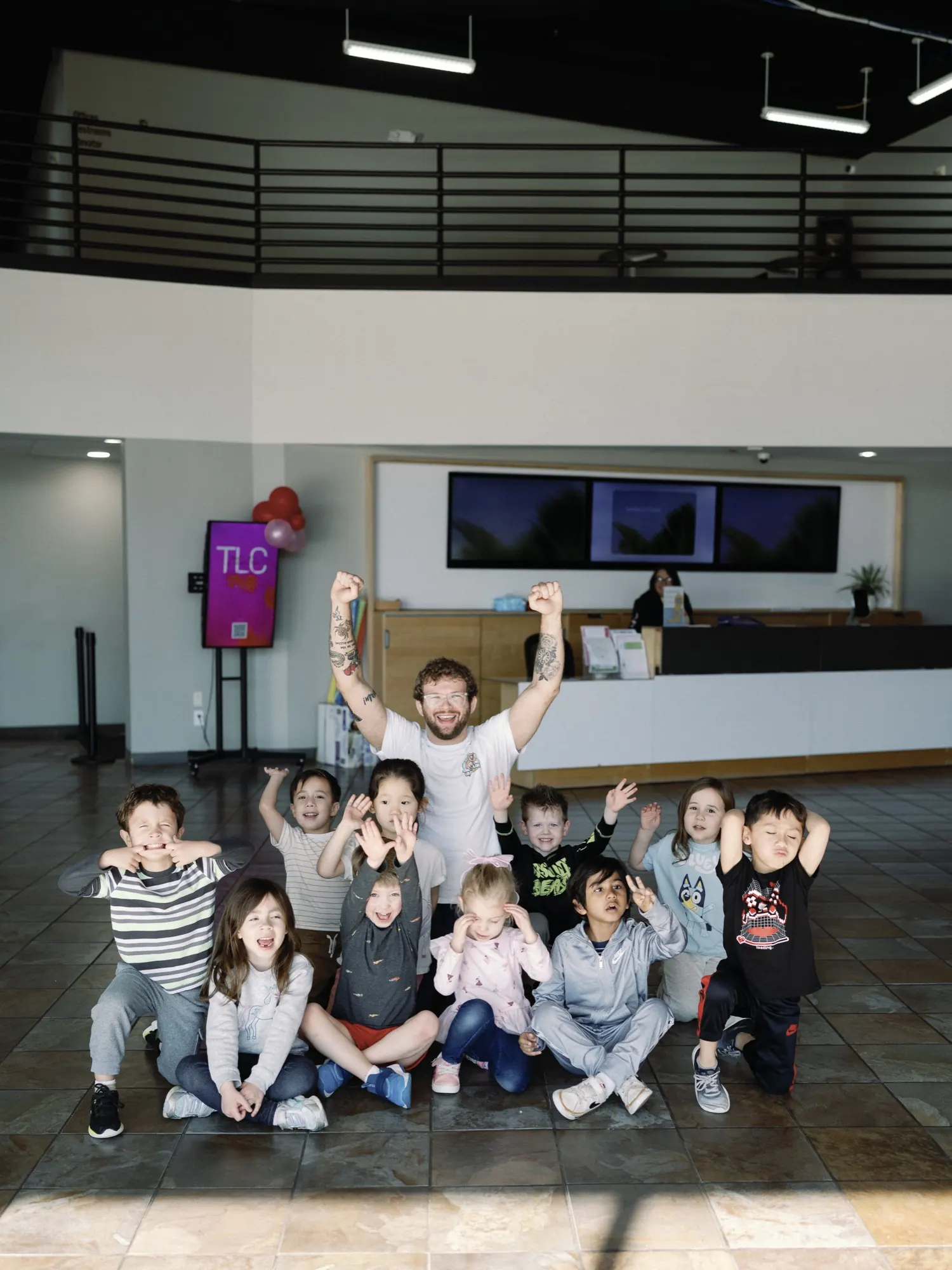 Coach Stephen supervising children during a non-striking grappling lesson