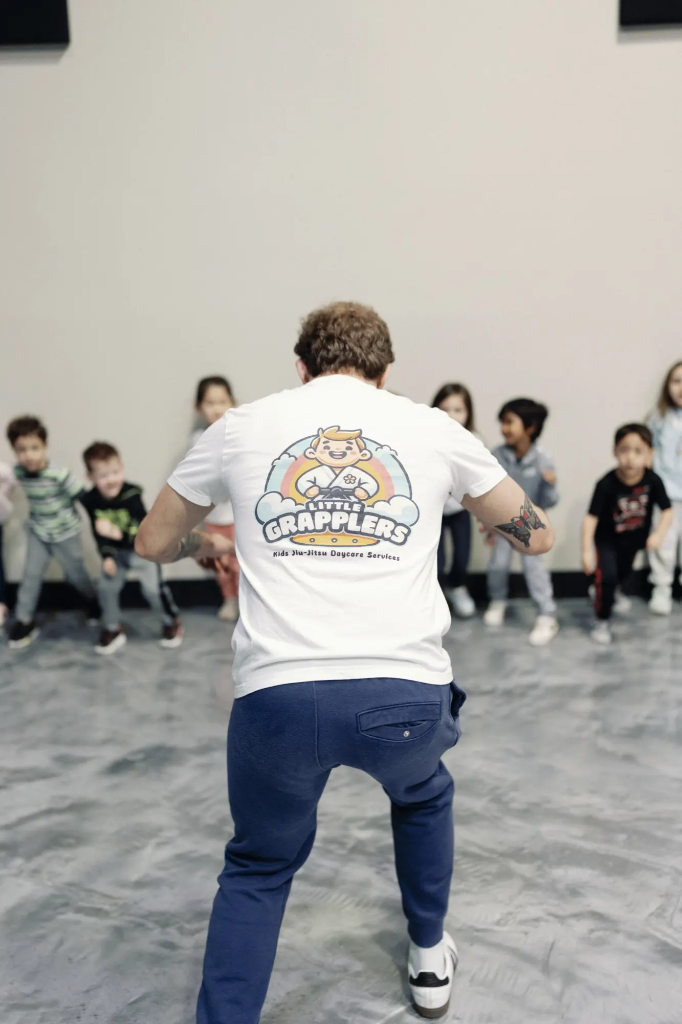 Coach Stephen leading young students through a school-day Little Grapplers lesson